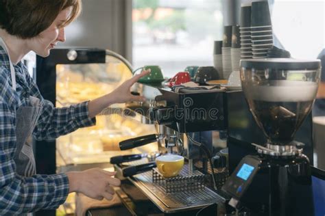 Women Barista In An Apron Making Coffee In A Coffee Shop Stock Photo