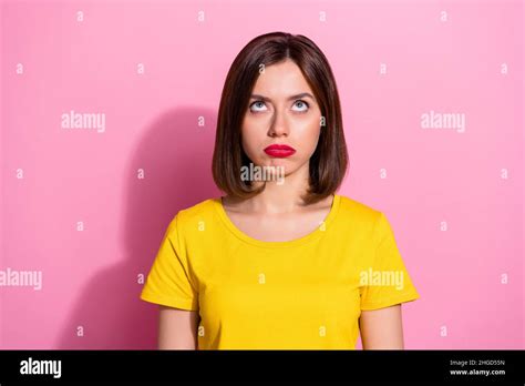 Portrait Of Attractive Bewildered Brown Haired Girl Looking Up Isolated