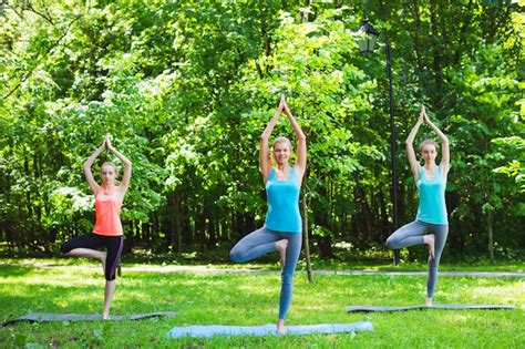 Premium Photo Fitness Group Doing Yoga In Park Pose Tree