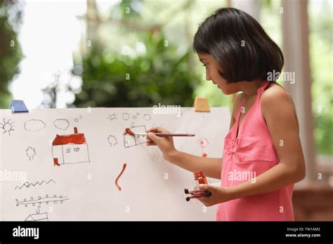 Girl Painting At Easel Stock Photo Alamy