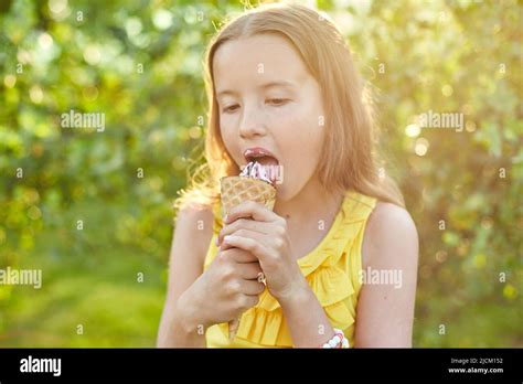 Happy Girl With Braces Eating Italian Ice Cream Cone Smiling While