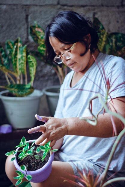 Premium Photo Woman Holding Potted Plant