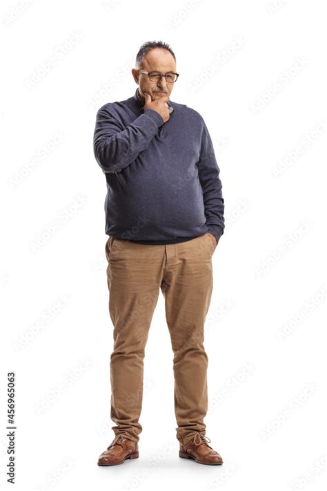 Full Length Portrait Of A Pensive Mature Man Standing And Thinking