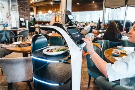 Robot Waiter Serve Food At Modern Restaurant Tableoffering Innovation