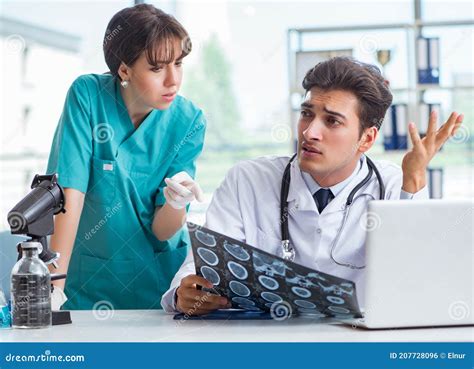 Two Doctors Discussing X Ray MRI Image In Hospital Stock Photo Image