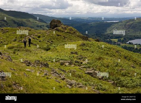 Two Walkers Descend From The Top Of Helm Crag Known Locally As The