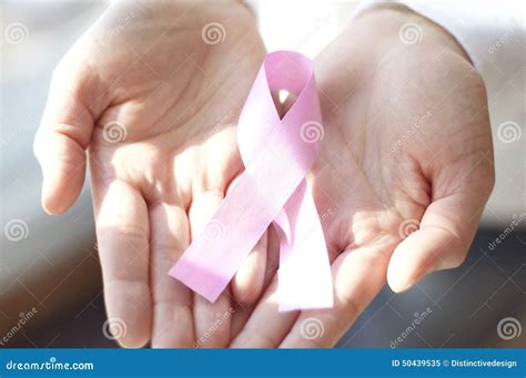 Womans Hands Holding Pink Breast Cancer Awareness Ribbon Stock Image