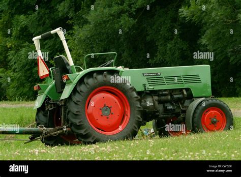 A Green Traktor Standing On A Pasture Stock Photo Alamy