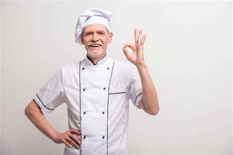 Premium Photo Senior Male Chief Cook In Uniform Gesturing Okay Sign