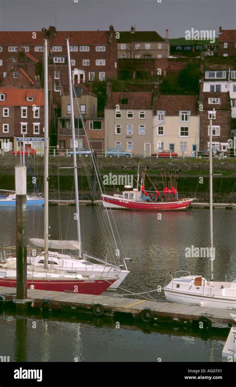 Moored Yachts With Coble Fishing Boat Beyond River Esk Whitby North