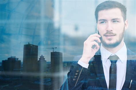 Retrato De Un Joven Empresario En Un Traje Azul Hablando Por Un