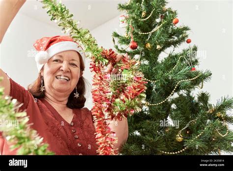 Happy Mature Hispanic Woman Smiling While Holding Green And Red