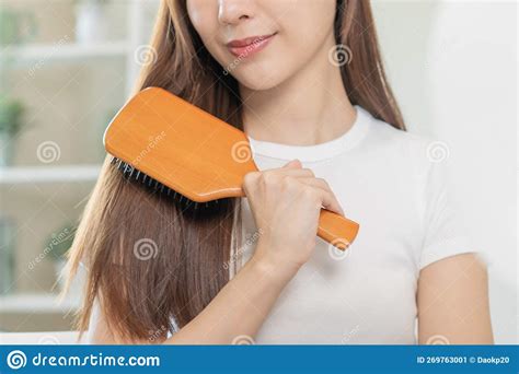 Health Hair Care Beauty Makeup Asian Woman Girl Holding Hairbrush And Brushing Combing Her