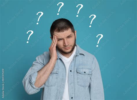 Amnesia Confused Man And Question Marks On Light Blue Background