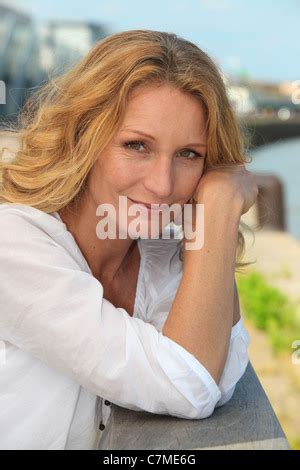 Beautiful Blonde Forty Year Old Woman With A Black Shirt And Necklace