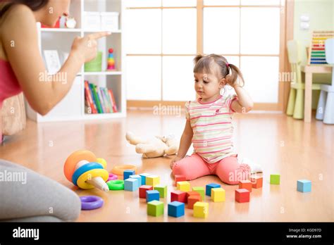 Children Cleaning Up Toys