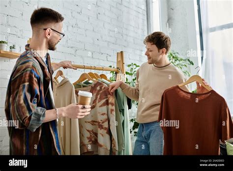 Two Men A Gay Couple Engaged In Creating Trendy Attire In A Designer Workshop Stock Photo Alamy