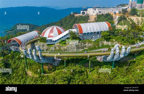 Aerial view of the Golden Bridge in Ba Na hills, Da Nang, Vietnam. Lifted by two giant concrete ...