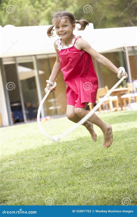 Girl Skipping In Garden Stock Photo Image 55897702