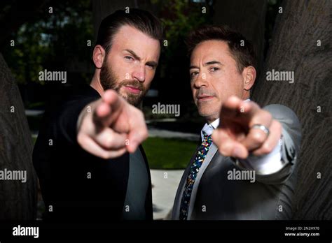 Chris Evans Left And Robert Downey Jr Pose During A Portrait Session