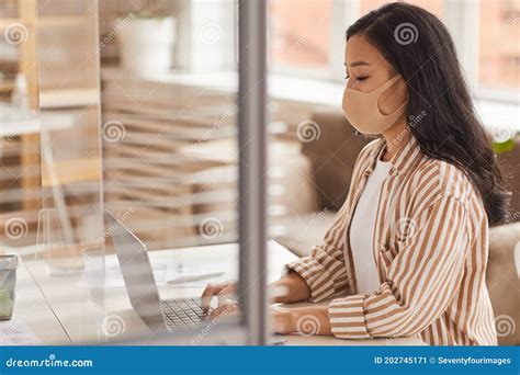 Asian Businesswoman Wearing Mask At Desk Stock Image Image Of