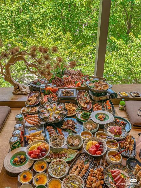 A Table Filled With Lots Of Food On Top Of A Wooden Table Covered In