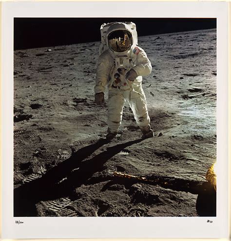 Neil Armstrong Buzz Aldrin Walking On The Surface Of The Moon Near A