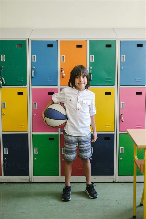 "Elementary School Pupil With Ball In Front Of Colorful Lockers" by Stocksy Contributor ...