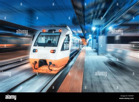 Moving Train On The Railway Station At Night Urban Landscape With