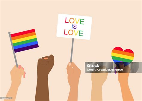 Hands Holding Lgbt Rainbow Flag And Placards During Pride Month