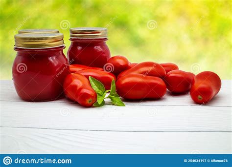 Traditional Italian Tomato Sauce In A Glass Jar With Fresh Tomatoes And Basil Copy Space Stock