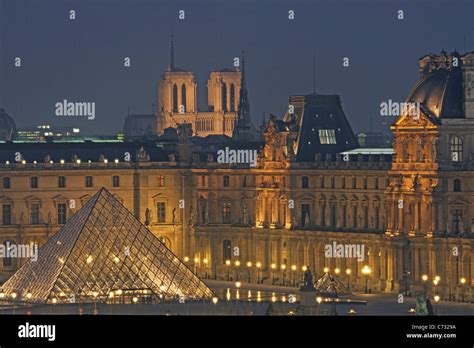 Louvre Museum With Im Pei Pyramide And Notre Dame In Background