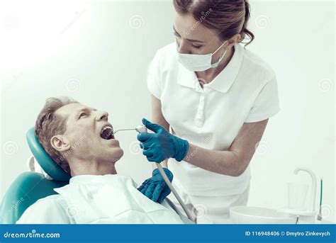 The Dentist With The Help Of A Carpule Syringe Injects Anesthesia Into