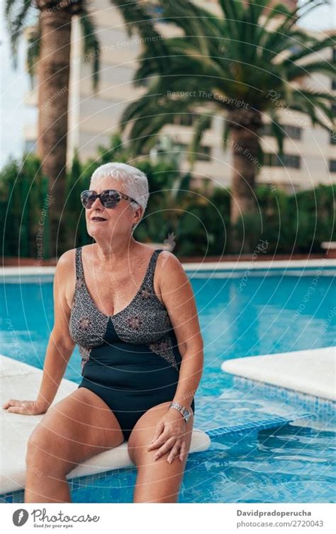 Senior Old Woman Grey Hair Sitting By The Swimming Pool A Royalty