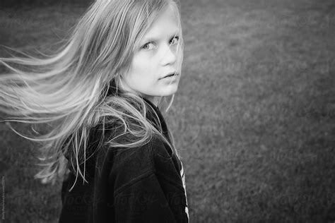 Girl With Long Hair Flying As She Turns To Look At The Camera By Stocksy Contributor Shelly