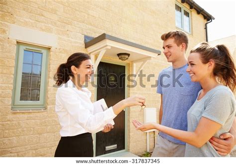 Female Real Estate Agent Giving Keys Stock Photo 317837345 | Shutterstock