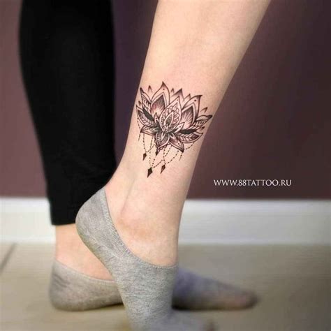 A Woman S Foot With A Lotus Tattoo On It