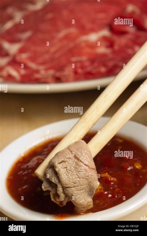 Mongolian Hot Pot Dipping Cooked Lamb In Chili Sauce Stock Photo Alamy