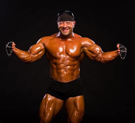 Premium Photo Bodybuilder In Black Shorts And Bandana Posing