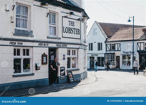 Man Stands By The Entrance Of The Lobster Pub In Sheringham Norfolk