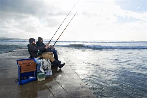 Premium Photo Friends Fisherman And Men By Ocean Fishing With Rod