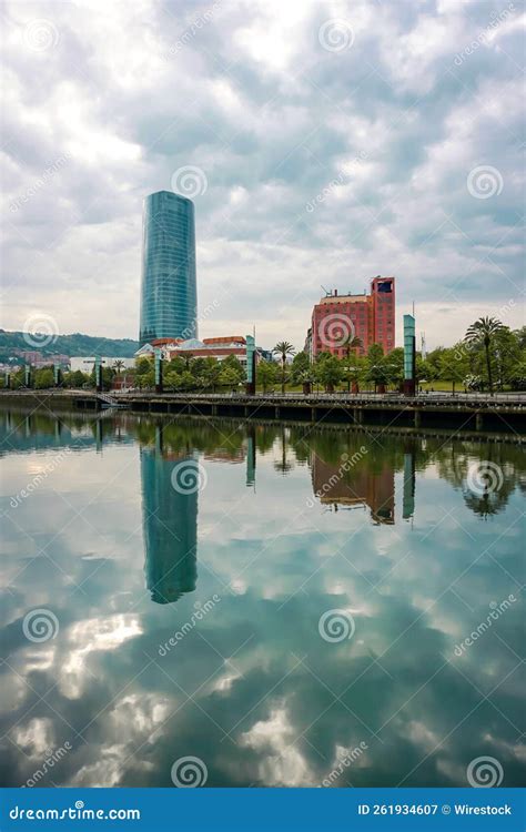 Scenic View Of Buildings Reflecting On A Calm River In Bilbao City