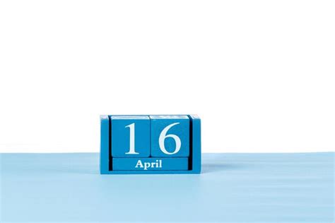 Premium Photo | Wooden calendar April 16 on a white background