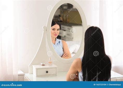 Beautiful Young Woman Looking At Herself In Mirror Stock Photo Image