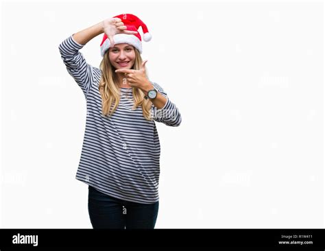 Young Beautiful Blonde Woman Wearing Christmas Hat Over Isolated