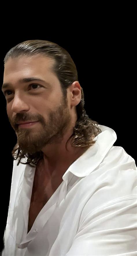 A Man With Long Hair And A Beard Wearing A White Shirt Is Looking At