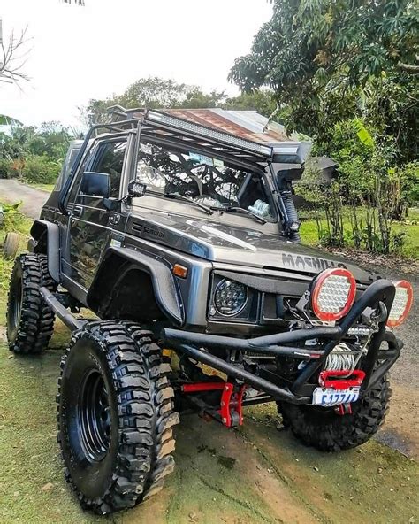 An Off Road Vehicle Parked On The Side Of A Dirt Road