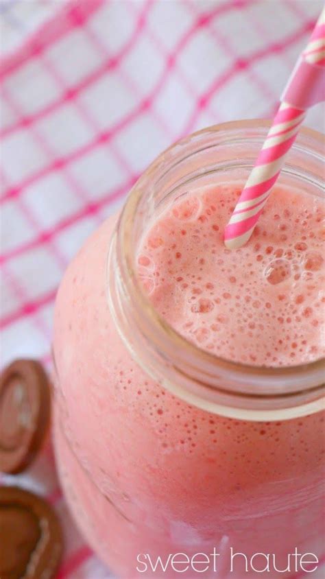 A Pink Smoothie In A Mason Jar With A Striped Straw