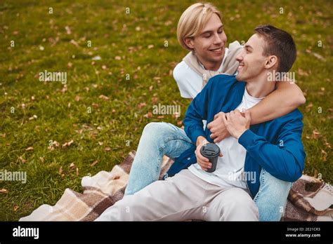 Loving Gay Couple Having Romantic Date Outdoors Two Handsome Men Sitting Together On Blanket In