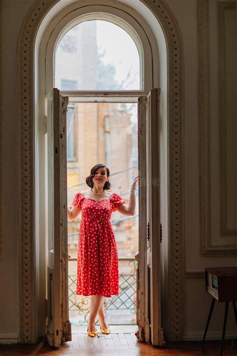 A Beautiful And Happy Brunette Women In Red Retro Dress In The Balcony